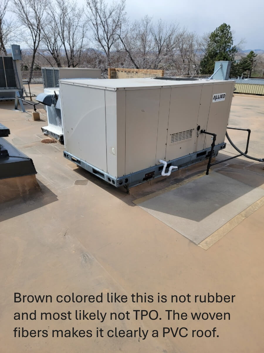 A commercial flat roof showing the woven fibers characteristic of a PVC membrane.